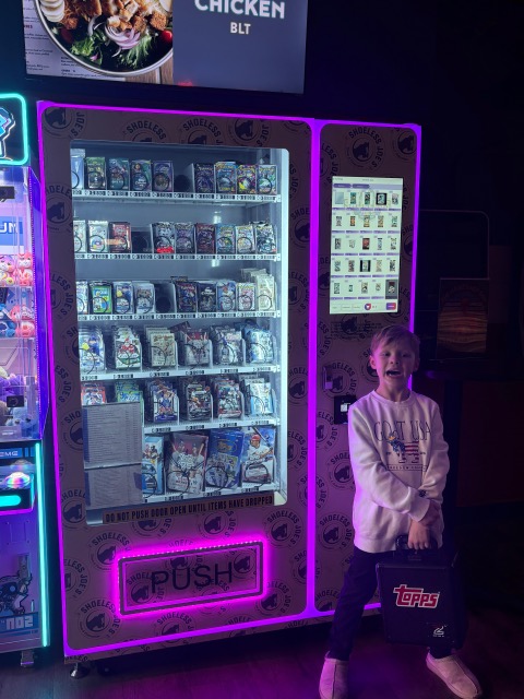 Customer at Shoeless Joe's sports card vending machine