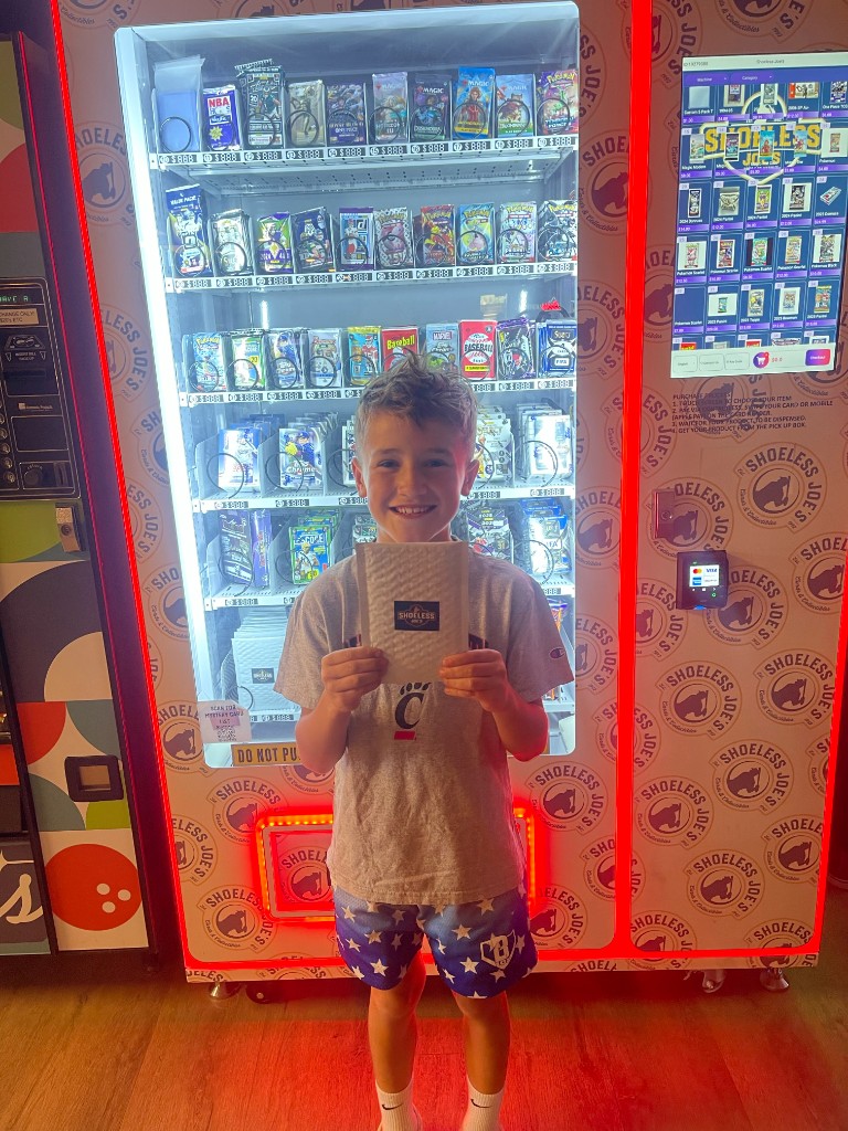Customer at Shoeless Joe's sports card vending machine